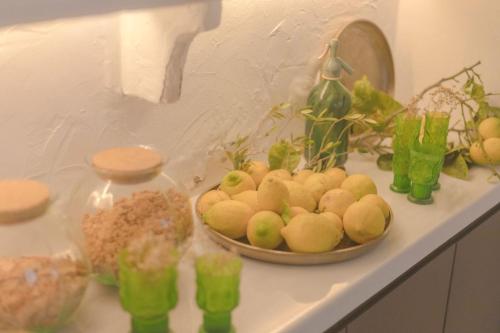 a bowl of fruit sitting on a counter with other items at Can Araya in Ciutadella