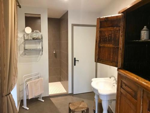 a bathroom with a sink and a toilet and a shower at Côté-Serein suites familiales du Clos in Noyers