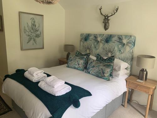 a bedroom with a bed with towels on it at Scarborough Hill Country Inn in North Walsham
