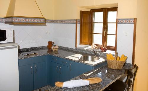 a kitchen with blue cabinets and a counter top at Casa Aurora in Navia