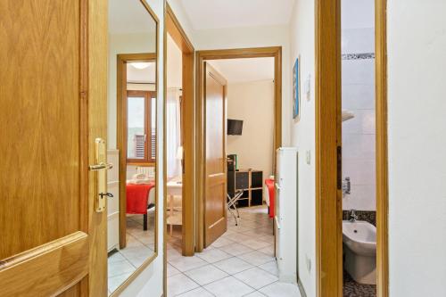 a hallway with a door to a bathroom with a toilet at Borgo Pinti Cozy Flat in Florence