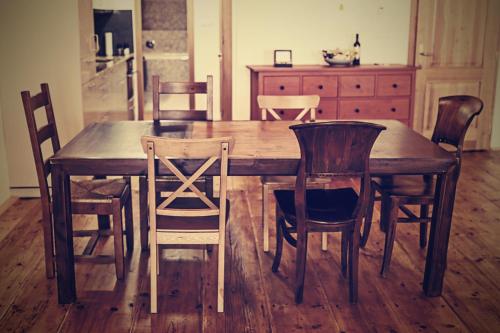 a wooden table and chairs in a kitchen at Bed&Bike Prachatice in Prachatice