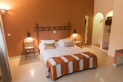 a bedroom with a large bed and two night stands at Airport Hotel Casino du Cap-vert in Dakar