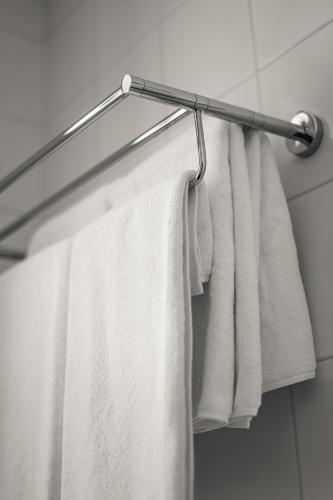 a group of towels hanging on a towel rack in a bathroom at Kolobok in Luts'k