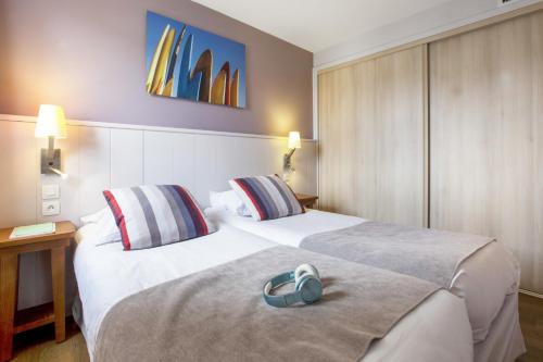 
A bed or beds in a room at Résidence Pierre & Vacances Premium Haguna
