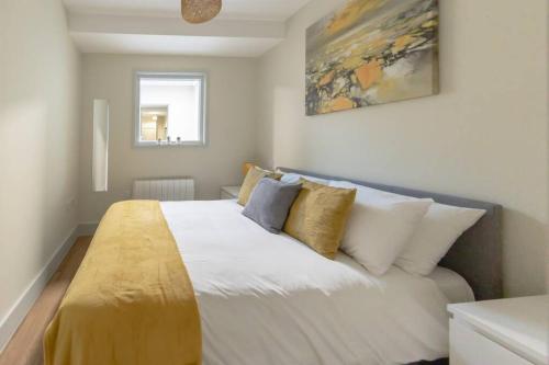 a bedroom with a large white bed with pillows at Apartment 3, Isabella House, Aparthotel, By RentMyHouse in Hereford