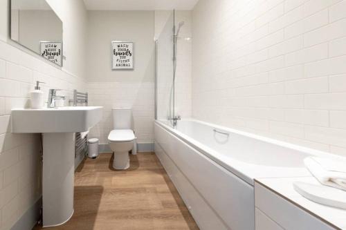 a white bathroom with a sink and a toilet at Apartment 3, Isabella House, Aparthotel, By RentMyHouse in Hereford