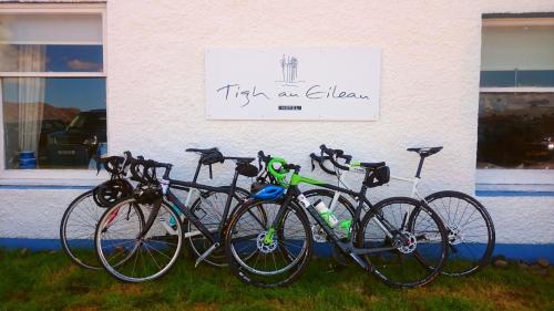 a group of bikes parked in front of a building at Tigh an Eilean Hotel in Shieldaig