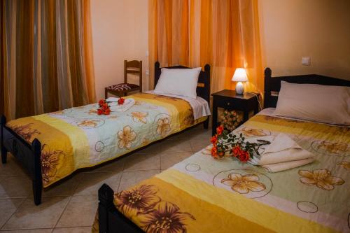 a bedroom with two beds with flowers on them at Betsis Apartments in Kipseli