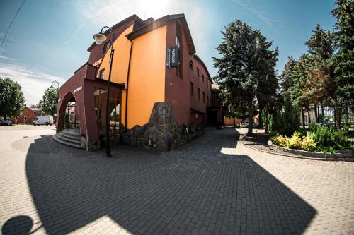 a building on a brick walkway next to a building at Kolobok in Luts'k