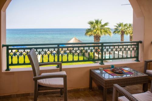 a balcony with a table and chairs and the ocean at Betsis Apartments in Kipseli