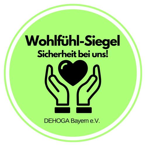 a green sign with the words wolfhug staffstatement be us at Park Hotel Laim in Munich