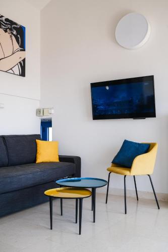 a living room with a couch and two chairs and a table at Penthouse in old Dalmatian house - Flybridge in Hvar