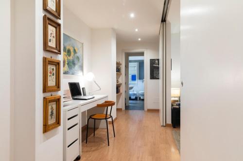 a room with a desk with a laptop and a chair at Dimora Certosa - Milano in Milan