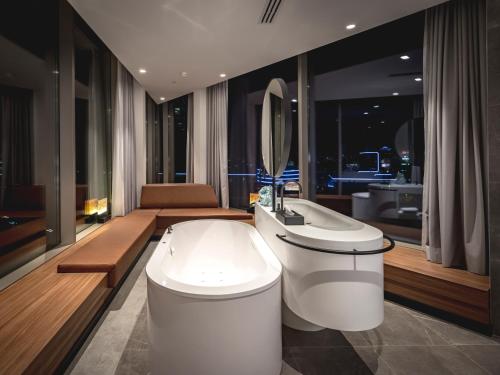 a bathroom with a toilet and a sink and a mirror at Van der Valk Hotel Amsterdam Zuidas -Rai in Amsterdam