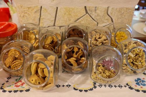 a group of glass containers filled with different types of food at Villa Tonia in Fasano