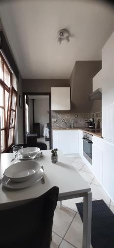 a kitchen with a table and a counter top at chez pépé Victor in Bouillon