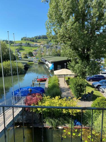 a view of a river with boats in it at Strandhotel Schmerikon in Schmerikon