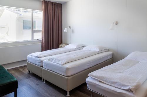 Postel nebo postele na pokoji v ubytování Guesthouse Hamar