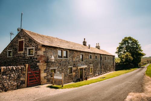 an old stone house on the side of a road at Laythams Holiday Lets Retreat in Slaidburn
