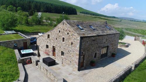 an aerial view of a stone building in a field at Laythams Holiday Lets Retreat in Slaidburn