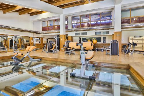 a gym with treadmills and exercise equipment on the floor at Pirin Golf & Country Club Apartment Complex in Bansko