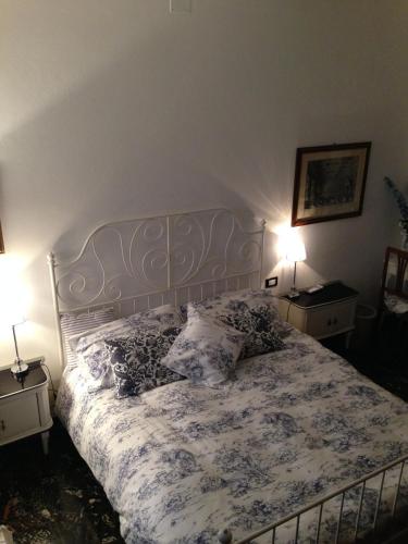 a bedroom with a bed with pillows and two lamps at Art&Kitchen in Savona