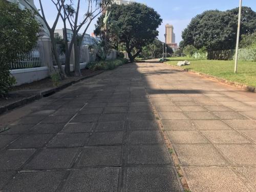 an empty street with trees on the side of the road at 111 Lescalier Cabanas - Amanzimtoti in Amanzimtoti