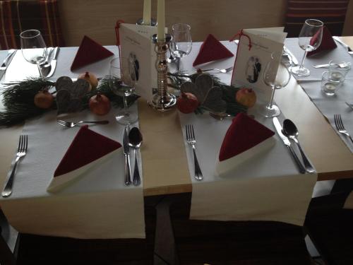 a table set for a meal with red and white napkins at Gasthof Wunder in Gnesau Sonnleiten