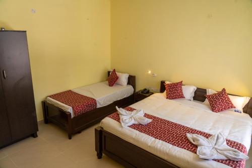 a bedroom with two beds with bows on them at VGR-HOMESTAY in Kodaikānāl