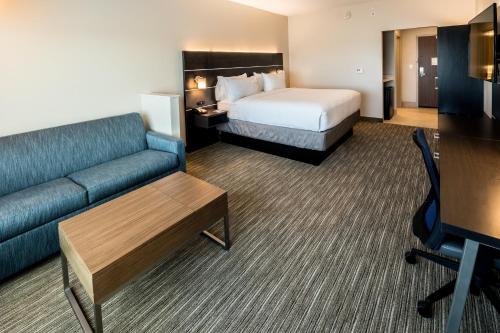 a hotel room with a bed and a couch at Holiday Inn Express - North Augusta South Carolina by IHG in North Augusta