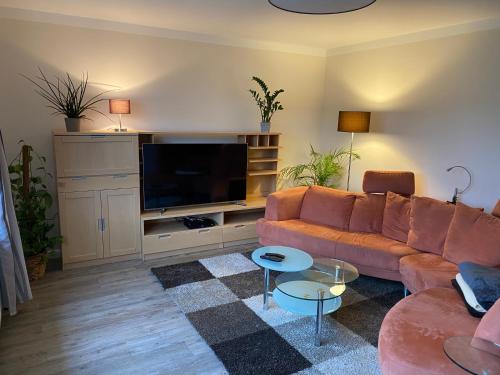 a living room with a couch and a flat screen tv at Ferienhaus an der Mühle in Klütz