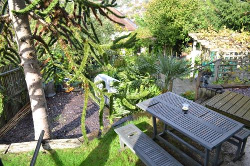 a picnic table and a bench in a garden at Greenfield Lodge in Brighton & Hove