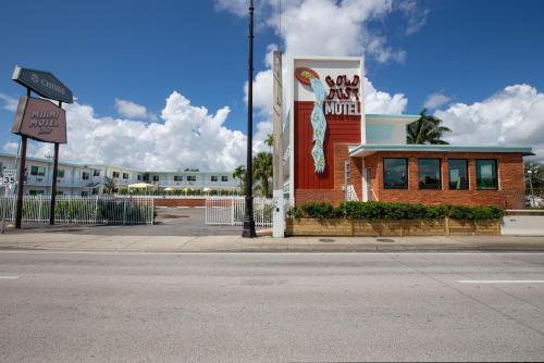 a large building with a sign on the side of it at Selina Gold Dust in Miami