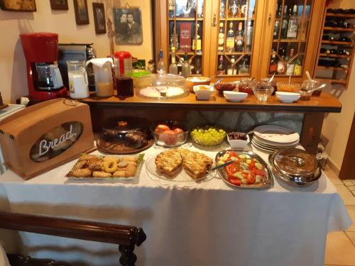a table with many different types of food on it at Semeli Guesthouse in Karpenision