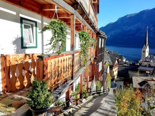 a balcony of a house with plants on it at Apartment Müllerstiege in Hallstatt