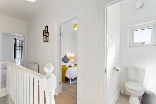 a white room with a bed and a toilet at Jasmine Villa A - Ideal for QMC & Uni - Free parking in Nottingham