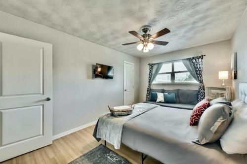a bedroom with a large bed with a ceiling fan at The Swank • Close to Downtown in Dallas