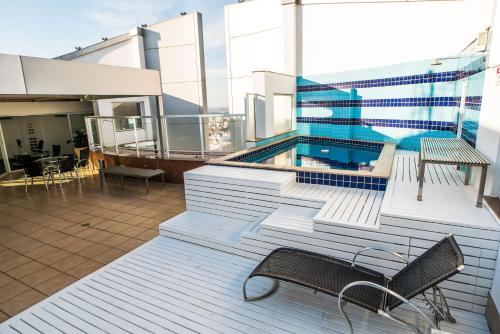 a balcony with a swimming pool on a building at Hotel Boulevard in Londrina