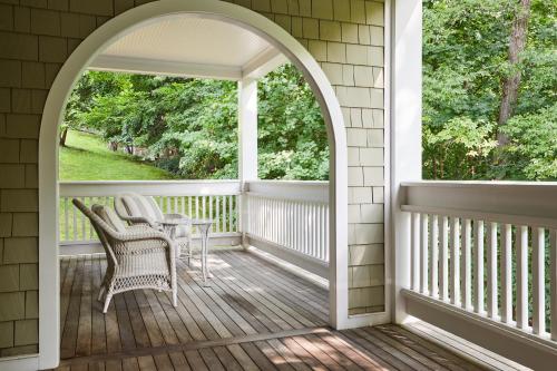 an arched doorway to a porch with a table and chairs at The Mayflower Inn & Spa, Auberge Collection in Washington