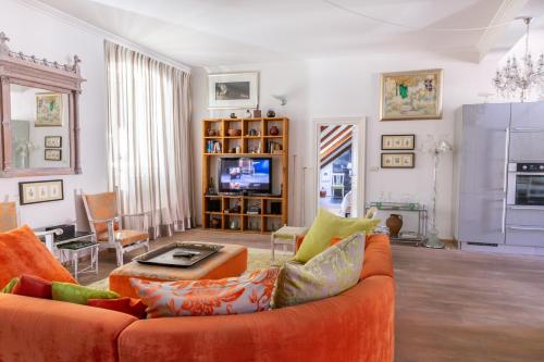 a living room filled with furniture and a tv at Dubrovnik Luxury Apartments in Dubrovnik