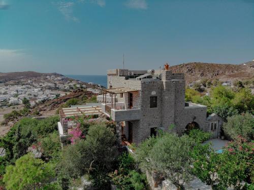 an old house on a hill with the ocean in the background at Blue Vista Patmos in Skala
