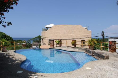 a swimming pool in front of a house at Villas Vista Suites Sayulita in Sayulita