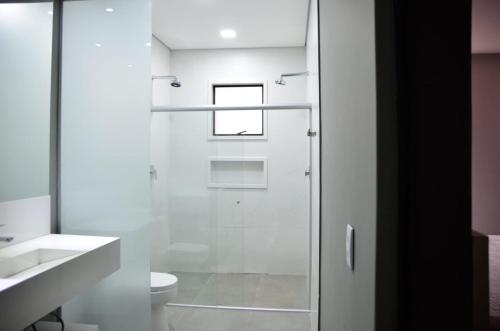 a bathroom with a shower and a toilet at Capão do Cerrado Pousada e Spa in Itabirito