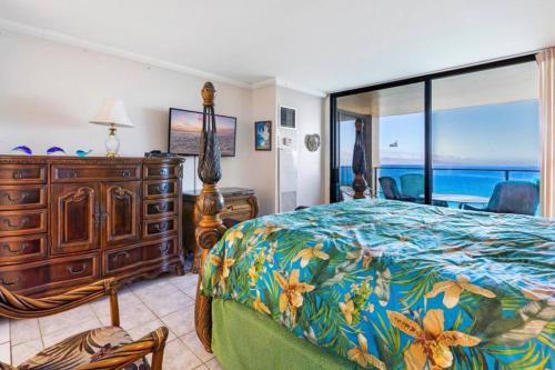a bedroom with a bed and a large window at Aston Mahana Kaanapali Beach Resort in Lahaina