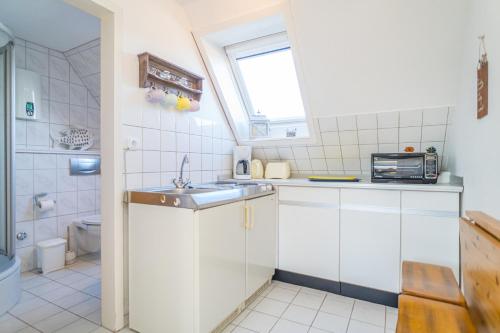 a small kitchen with a sink and a toilet at Falkennest 2 in Westerland (Sylt)
