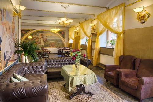 a living room filled with furniture and a large window at Hotel Taurus in Prague