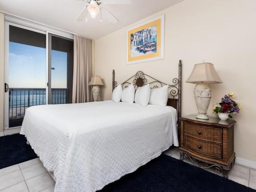 a bedroom with a white bed and a window at Summerwind in Navarre