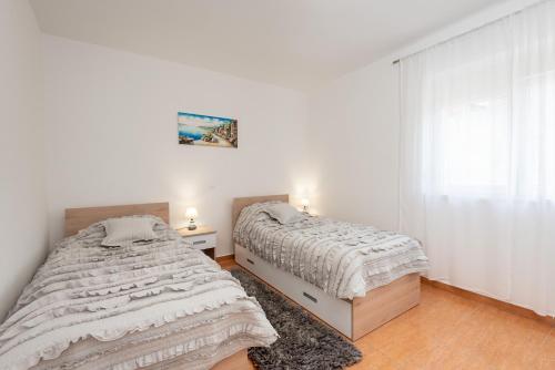 Postel nebo postele na pokoji v ubytování Apartman Galov