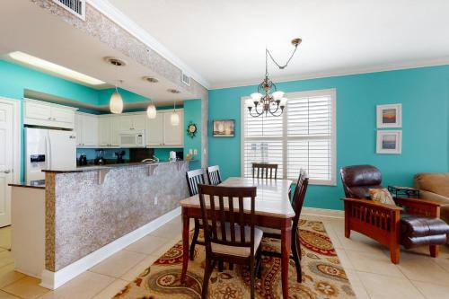 a kitchen and dining room with a table and chairs at Summer Place in Fort Walton Beach